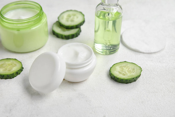 Natural cosmetics, cucumber slices and cotton pads on light table - Fotoğraf, Görsel