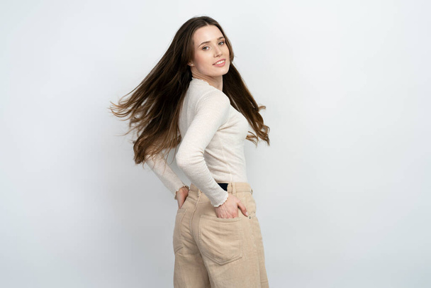 Portrait of beautiful happy brunette woman with healthy long hair posing for picture isolated on white background. Beauty, hair care concept  - Fotografie, Obrázek