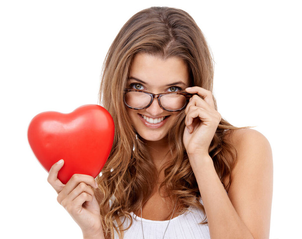 Shes ready for valentines day. Portrait of an attractive young woman holding a heart-shaped prop - Foto, Imagem
