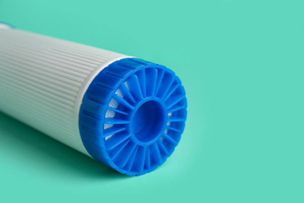 New water filter cartridge on green background, closeup - Фото, изображение