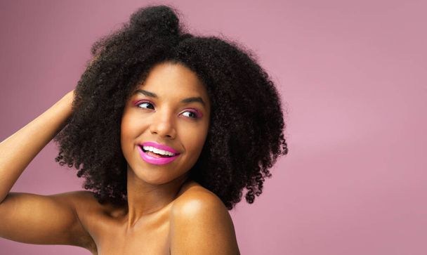 Love thy fro. Studio shot of an attractive young woman posing against a pink background - Photo, Image