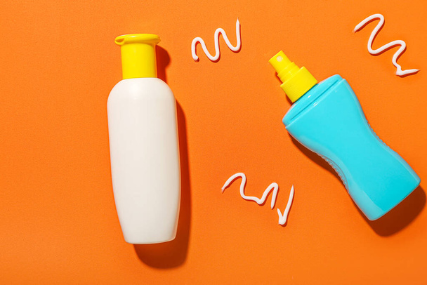 Different sunscreen creams on orange background - Photo, Image