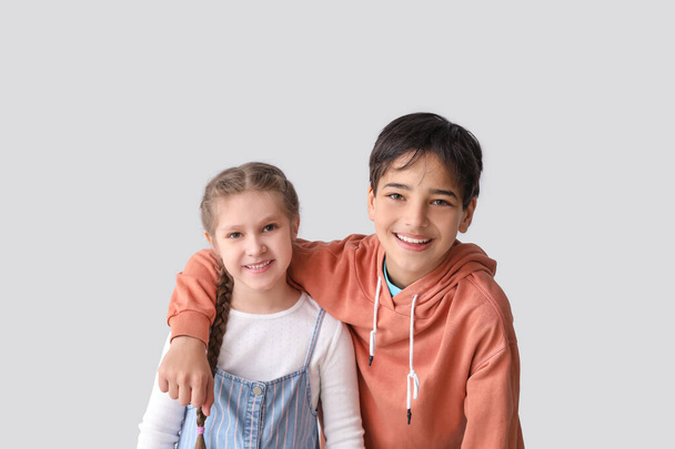 Kleine Kinder umarmen sich auf hellem Hintergrund - Foto, Bild