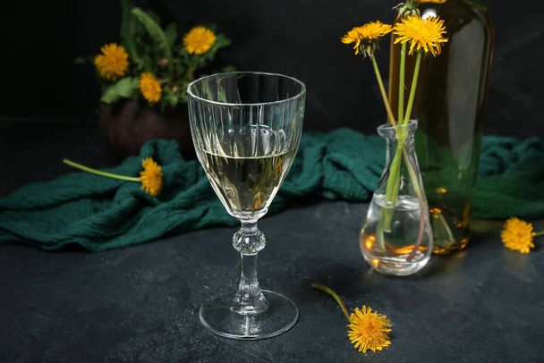 Glass of dandelion wine on dark table - Fotografie, Obrázek