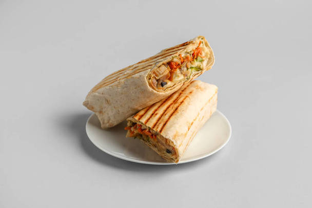 Plate with tasty shawarma on grey background - Fotó, kép