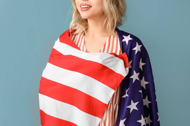 Young woman with USA flag on blue background, closeup - Photo, Image