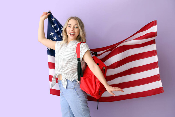 Female student with USA flag on lilac background - Foto, immagini