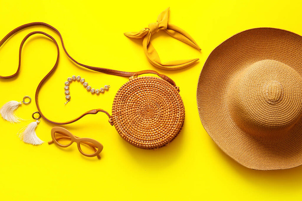 Stylish bag and different accessories on yellow background - Photo, image