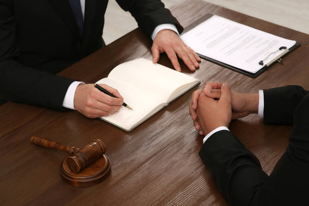 Law and justice. Lawyers working with documents at wooden table, closeup - Foto, Imagem