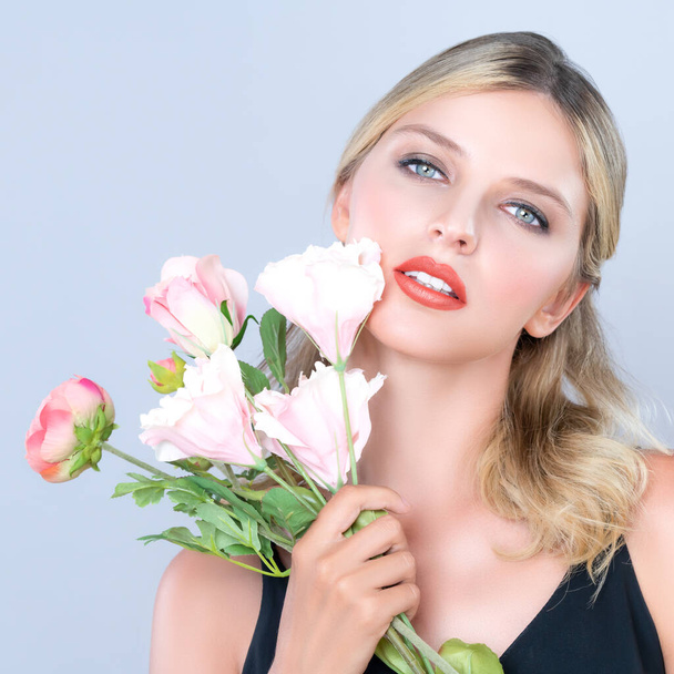 Closeup young woman with alluring flawless makeup and healthy soft skin holding rose for natural skincare treatment advertising in isolated background. Beautiful pretty model girl with flower concept. - Fotografie, Obrázek