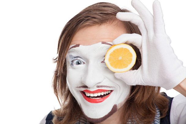 mime actor attaching to face lemon - 写真・画像