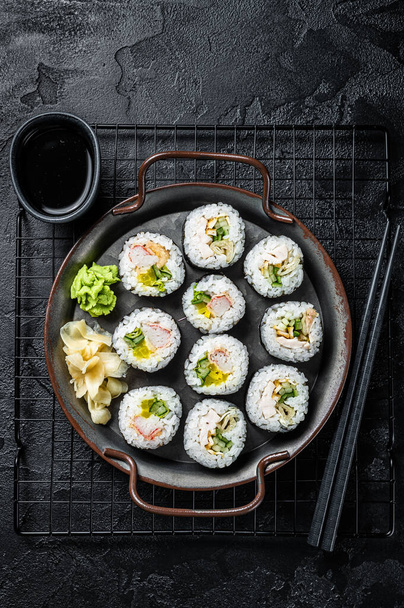 Kimbap gimbap filled with vegetables, egg, eanchovy and crab, Korean rice roll. Black background. Top view. - Photo, image