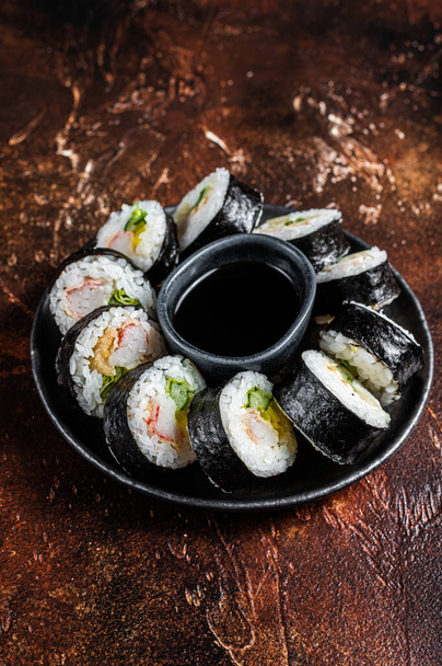 Korean rice roll Kimbap or gimbap made from steamed white rice. Dark background. Top view. - Photo, image