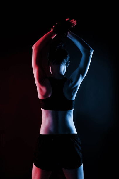 Attractive Sporty Young Caucasian Woman Doing Workout Exercise. Red and Blue toned Portrait Photo - Фото, зображення