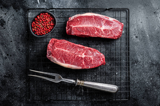Raw top blade cut organic beef meat. Black background. Top View. - Foto, Imagem