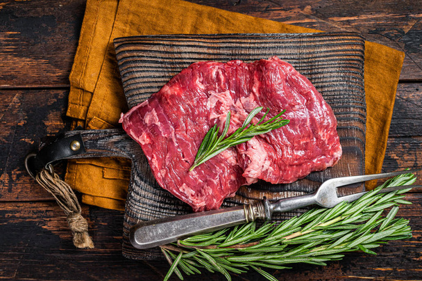 Raw alternative skirt beef steak on butcher board. Wooden background. Top view. - Фото, изображение