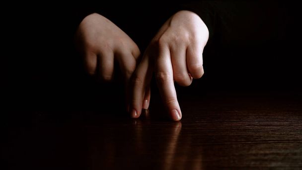 Male fingers dancing on a dark background. Fun and theater concept - 写真・画像