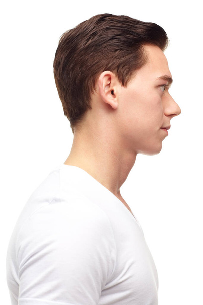 Fashion, face and profile of man on a white background with confidence, thinking and thoughtful expression. Skincare, beauty and isolated male person looking with casual, trendy clothes in studio. - 写真・画像