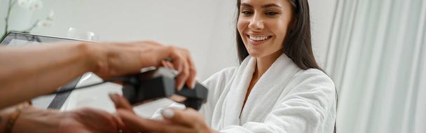 Woman in white bathrobe on medical examination before procedures in spa salon. High quality photo - Foto, imagen