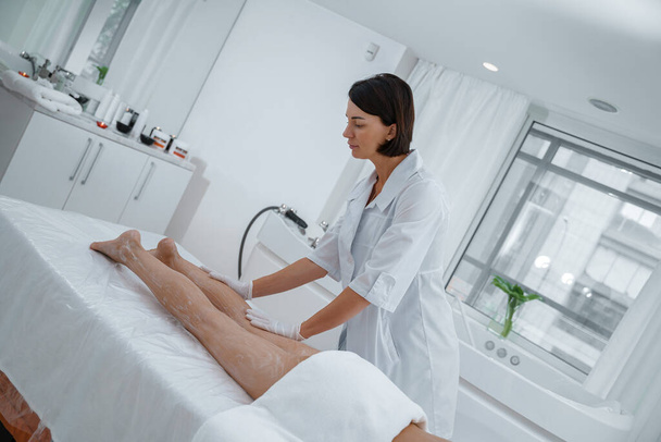  Woman enjoying procedure of legs massage in spa salon. Beauty concept. High quality photo - Φωτογραφία, εικόνα