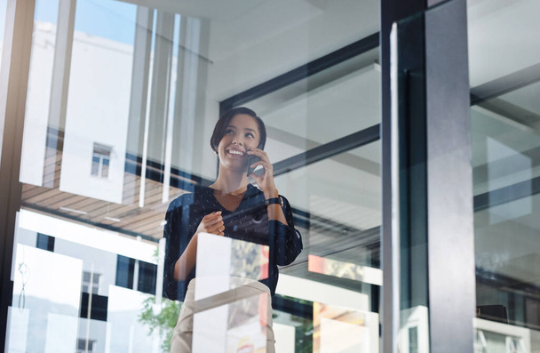Never hangup on success. a young businesswoman talking on a cellphone in an office - Φωτογραφία, εικόνα