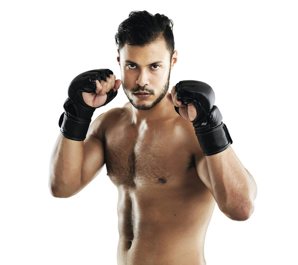 Building his punching power. Studio shot of a fit young man wearing boxing gloves against a white background - Foto, Imagen