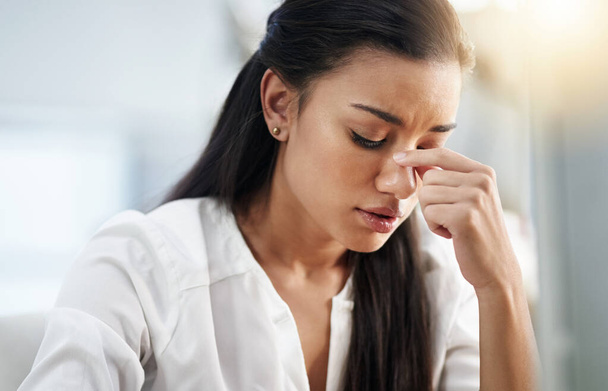 Business, burnout or woman with headache, stress or tired in office with fatigue, anxiety or depression. Depressed employee, sad female consultant or person frustrated with migraine pain in workplace. - Фото, изображение