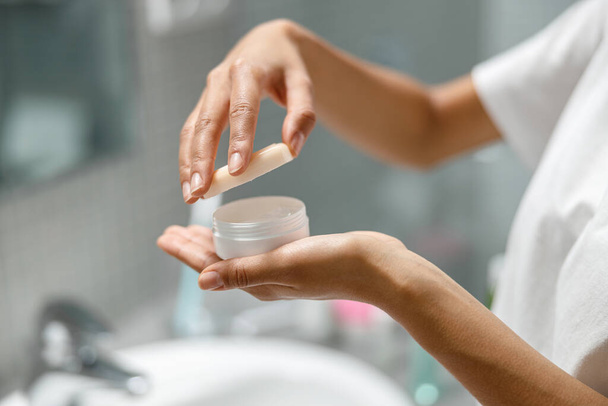 Woman holding jar with moisturizer cream for face. Skincare routine. High quality photo - Φωτογραφία, εικόνα