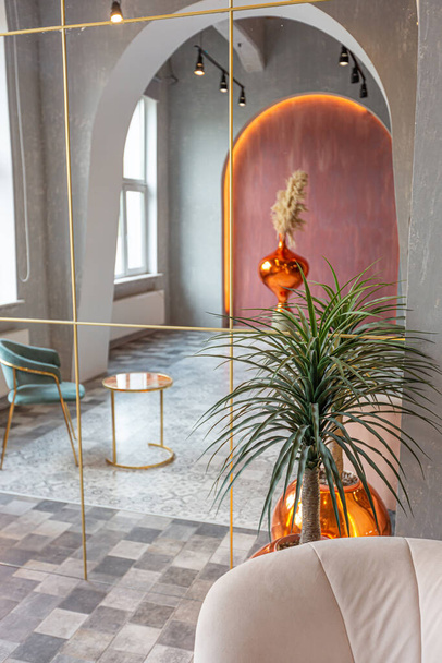 interior of a large apartment in oriental mixed with loft style with arches, led lighting and bright orange elements - Zdjęcie, obraz