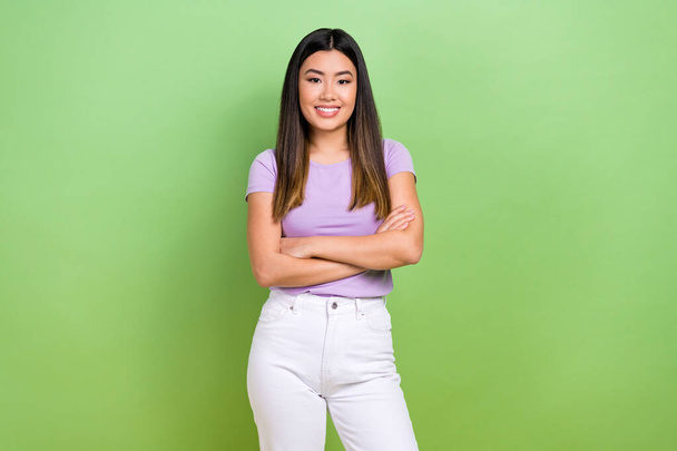 Photo of confident chinese business lady wear purple t-shirt crossed hands satisfied project manager isolated on green color background. - 写真・画像