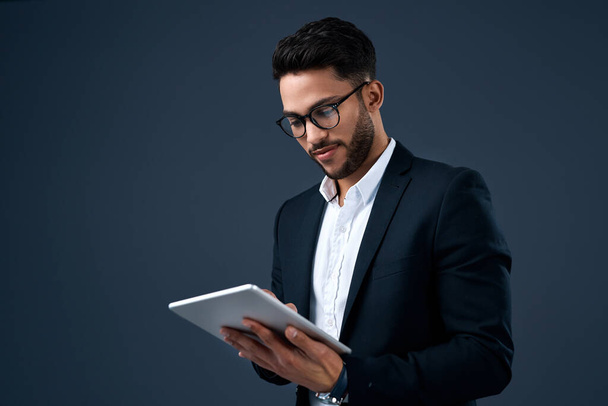 Technology, professional young businessman with tablet and in a studio background. Social networking or digital communication, isolated and male person with mobile device search on backdrop - Φωτογραφία, εικόνα