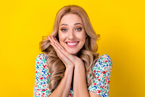 Closeup portrait of stunning lovely blonde wavy hair girl hands together model expect your present isolated on yellow color background. - 写真・画像