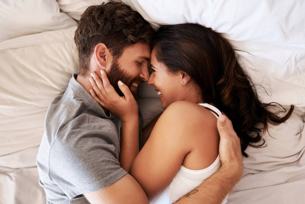 Největší štěstí života je láska. láskyplný mladý pár objímající se doma v posteli - Fotografie, Obrázek
