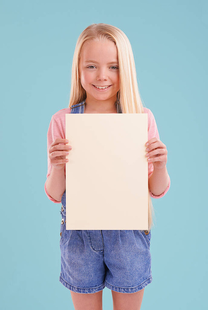 Heres what I think...A cute little girl holding up colorful copyspace while isolated - Foto, Imagen