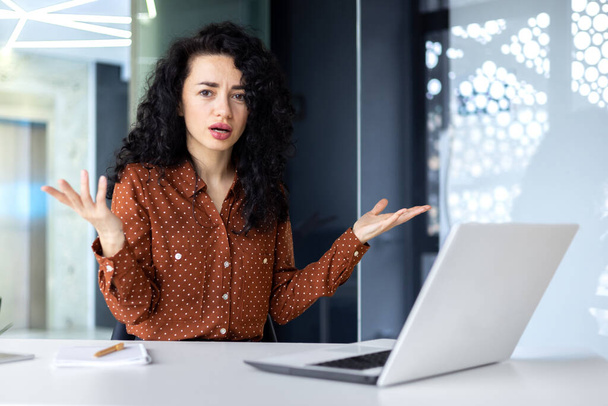 Frustrated and sad woman inside office looking at camera, businesswoman unhappy with achievement results working at desk using laptop at work. - Foto, Bild