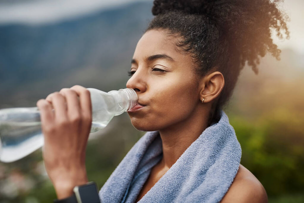 Nawodnienie jest kluczowe dla wydajności. sportowa młoda kobieta pijąca wodę podczas ćwiczeń na świeżym powietrzu - Zdjęcie, obraz