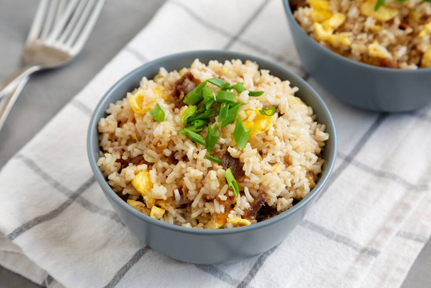 Homemade Fried Rice with Bacon and Egg in a Bowl, side view. - 写真・画像