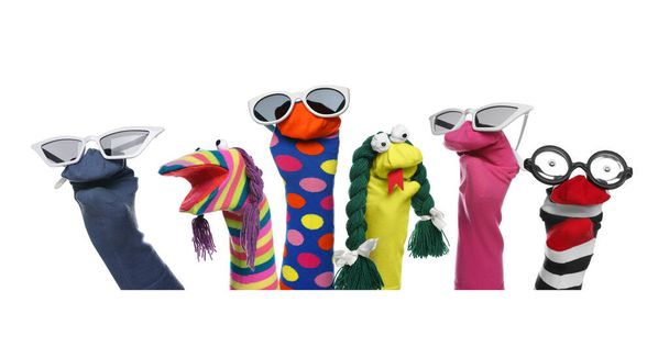 Many colorful sock puppets on white background, collage design - Fotó, kép