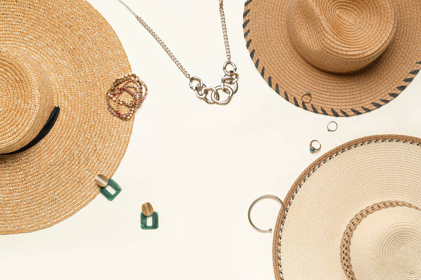 Frame made of summer hats with jewelry on light background - Fotografie, Obrázek