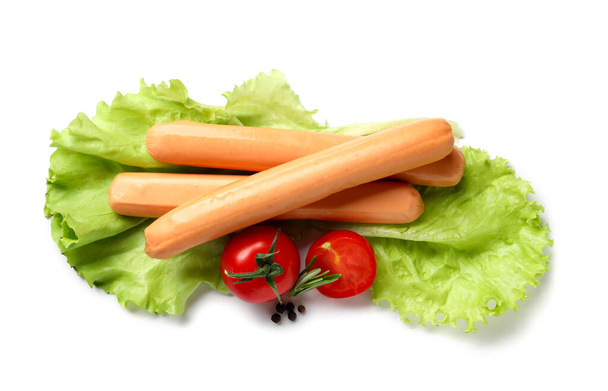 Tasty sausages with lettuce and tomatoes on white background - Photo, Image