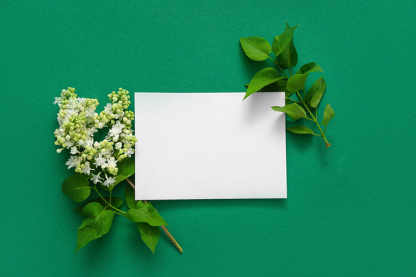 Blank card with lilac flowers on dark green background - Fotoğraf, Görsel