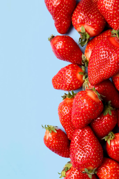 Fresh strawberries on blue background - Фото, изображение