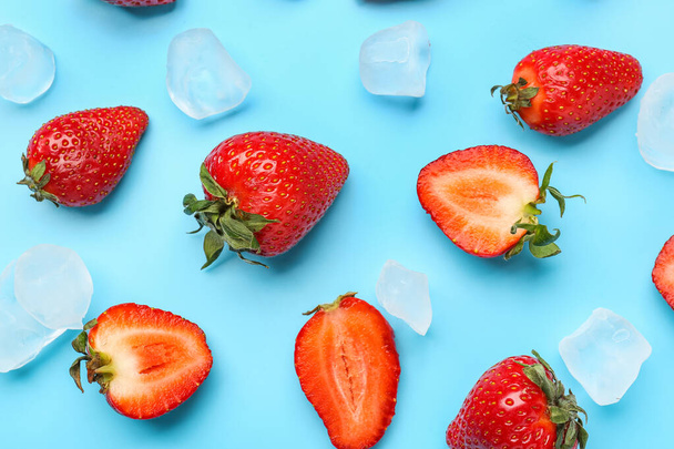 Fresh strawberries with ice cubes on blue background - Photo, image
