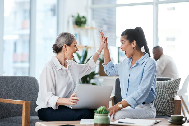 We made it happen. two businesswomen giving each other a high five while working together in an office - Zdjęcie, obraz