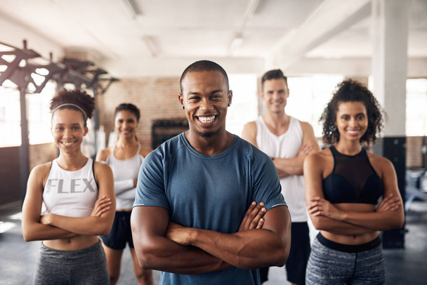 Were here to keep you motivated. Portrait of a group of confident young people working out together in a gym - Foto, Imagem