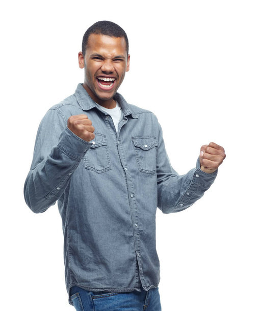 Yes, excited and man celebration portrait in studio with casual fashion and happiness from win. Smile, winning and achievement of a African male and model with white background and winner fist. - Fotografie, Obrázek