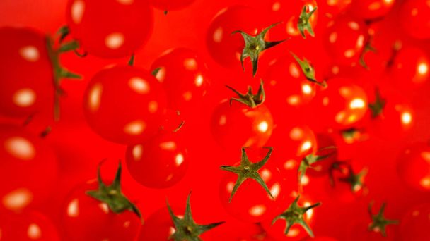 Freeze motion of flying fresh cherry tomatoes, macro shot - Valokuva, kuva