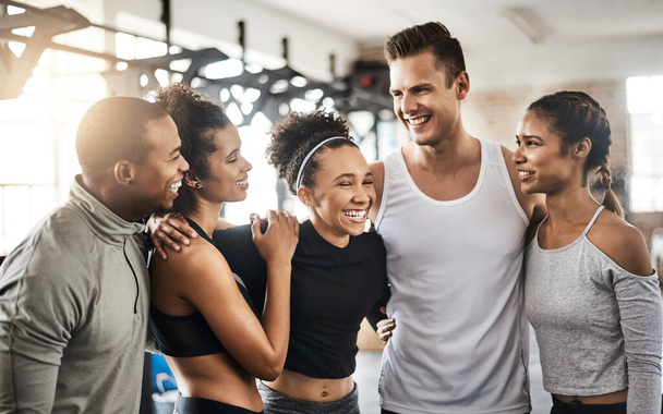 Some of the best friendships are formed in the gym. a group of happy young people working out together in a gym - 写真・画像