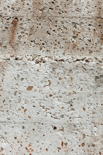 Grunge texture close up. Old damaged stone wall background. Fragment of a wall with little rocks. Easily add depth and organic texture to your designs. Abstract background. - Photo, image