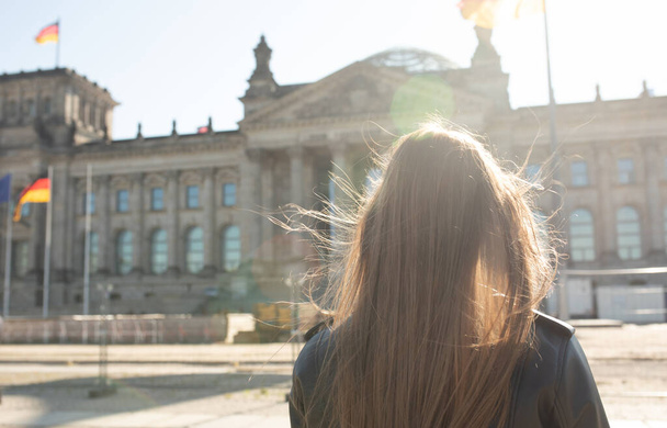 Young woman posing in front of the German Parliament on her sightseeing tour in Berlin, Germany. Bundestag. - Photo, image